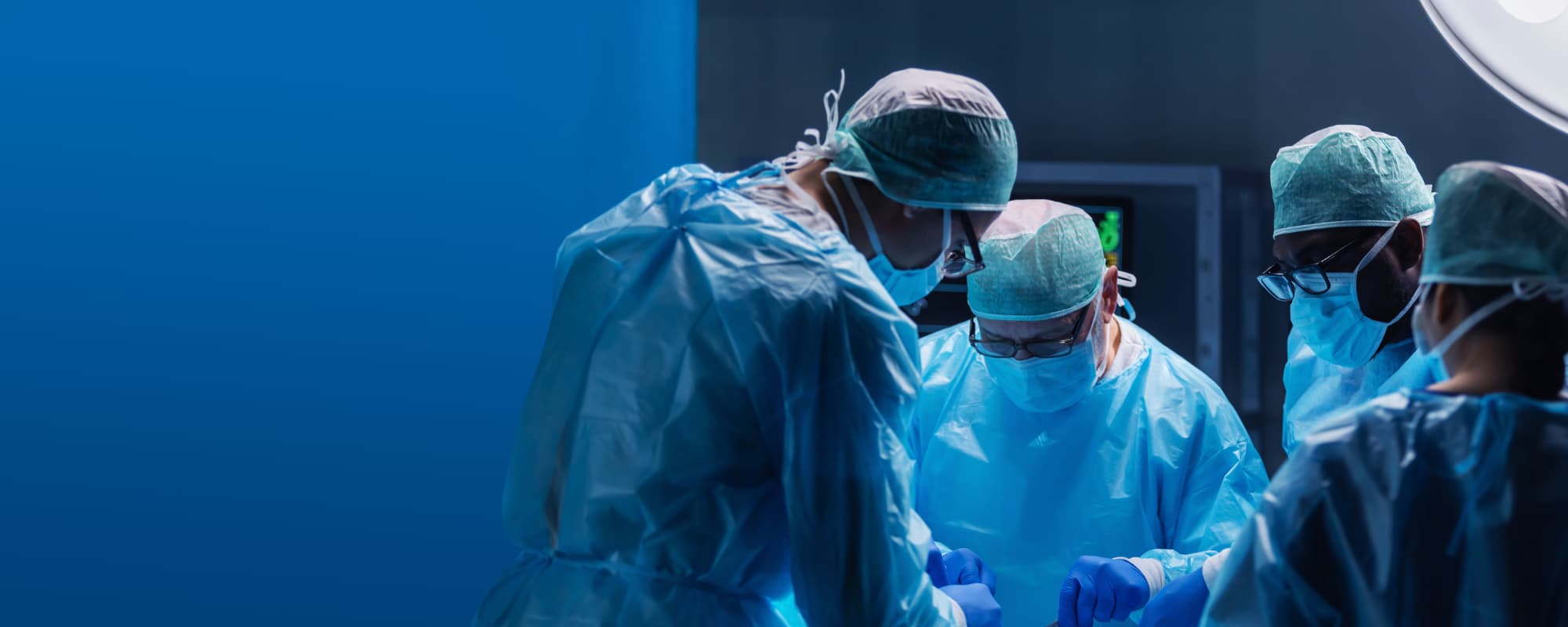 Medical surgeons perform surgery in the operating room using high-tech equipment.