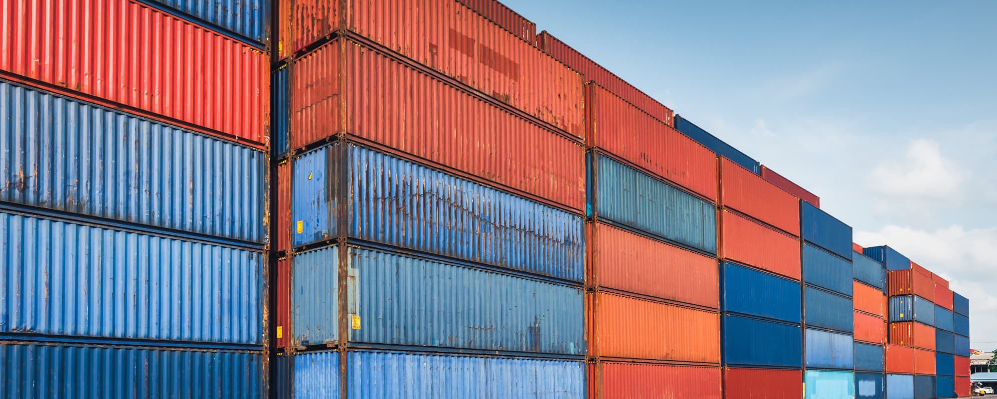 Stacked red and blue shipping containers.